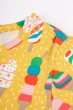 Close up of the popper closures on the Frugi Dara Baby Body Dress with a yellow Rainbow Sprinkles design 