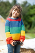 Brown haired girl wearing Frugi Rainbow stripe knitted childrens jumper holding binoculars