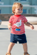 child smiling wearing the Frugi Easy On Outfit - True Red Stripe/Seagull/Indigo