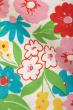 Close up of the coloured flowers on the Frugi Soft White Flowers Elowen Dress pictured on a plain background