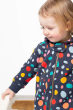 child wearing the Frugi Switch Snuggle Suit - Indigo Dalmatian