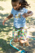 Child wearing the Frugi Tide blue Breton striped Bicycle Elise Applique T-Shirt with matching all over print shorts 