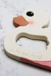 Close up of Hevea Natural Rubber Teether - Kawan the Duck  on a white marble background