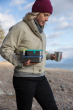 Woman carrying Klean Kanteen metal food box set, stacked in her hand while walking along a beach