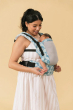 Adult carrying a baby with the Tula Free To Grow Paradise print Baby Carrier