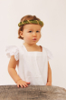 Child wearing the vah green Isabella Medieval Veil and a white dress