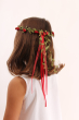 Child wearing the Vah red Flower Crown. View of back of child's head