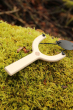 vah wooden sling shot placed on moss outdoors