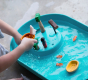 Close up of child playing with the Plan Toys Water Play Set - an exciting play tray inspiring creative water play and is a fabulous sensory toy for toddlers. 