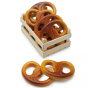 A collection of Erzi Pretzel Wooden Play Food in a wooden crate, on a white background.