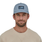 Man wearing the Patagonia eco-friendly light plume grey 73 skyline trad cap on a white background