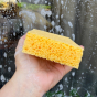 Close up of hand holding the A Slice of Green compostable cellulose household sponge