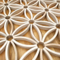 Close up of the Abel mini curved wooden toy blocks arranged in a pattern mandala on a wooden floor