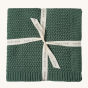 Avery Row Plait Knit Baby Blanket - Pine Green. A beautifully plait knitted baby blanket in a rich, green colour, wrapped up in an Avery Row branded ribbon.