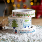 A stack of Christmas design babipur eco recyclable paper tapes. English Merry Christmas, Christmas camper wide parcel tape and Welsh Nadolig Llawen design