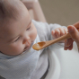 baby being fed a pureed food with a Bambu baby feeding spoon