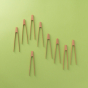 lots of tiny tongs pictured on a plain green background