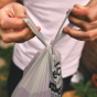 Close up of hands holding Beco Pets sustainable biodegradable dog poo bags