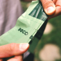Close up of hands tearing a roll of Beco Pets eco-friendly dog poop bags