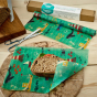 Close up of a sandwich on a small piece of the Beeswax Wrap Company plastic free food wrap up sheet on a wooden table
