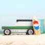 One retro style magnetic wooden surfboard toy leaning on a Candylab car on the beach.