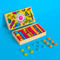 Billes & Co kids recycled glass Memphis marble set open on a blue background with some coloured marbles scattered in front of the box