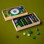 Billes & Co kids magic forest glass marbles laid out on a dark green background, showing some different coloured glowing marbles 