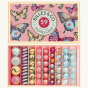 Billes & Co Butterfly Anamorphic Glass Marbles Set box, with various pink, blue, yellow and frosted marbles inside their box, on a cream background