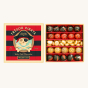 Billes & Co Pirate Treasure Glass Marbles Set box, with red, black  and yellow spots and swirls marbles in a red and black stripe treasure box, on a cream background