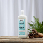 Bio-D Home & Garden Vegan Cleaner in a refillable 750ml bottle on a wooden table with white background and pine cones