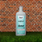 Bio-D Home & Garden Vegan Cleaner in a refillable 750ml bottle on a brick background and grassy floor