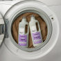 Bio D eco-friendly vegan lavender laundry liquid 1L bottle and conditioner 1 Litre bottle, propped up in a white washing machine