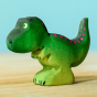 Wooden toy baby T-Rex in vibrant shades of green and purple. The baby T-Rex stands upright in a forward stance. The toy has painted eyes, claws, and body detail.