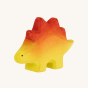 Bumbu hand carved wooden Stegosaurus baby with hand painted yellow body and red back scales, on a cream background