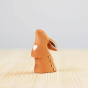 Close up of the Bumbu handmade wooden curious rabbit toy on a wooden worktop