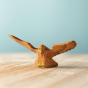 Close up of the Bumbu childrens wooden eagle toy figure on a wooden worktop
