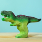 Wooden toy adult T-Rex in vibrant shades of green and purple. The T-Rex stands upright with its jaws open in a forward stance. The toy has painted teeth, claws, and eye detail.