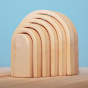 Bumbu Natural Wooden Stacking Arches. The toy sits on a wooden surface against a blue background.
