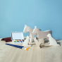 Bumbu Wooden Farm Animal Set - Paint Your Own. The toy sits on a wooden surface against a blue background.