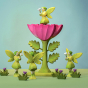 The Large Pink Flower by Bumbu is an impressive wooden flower with four leaves and a rich pink bloom, it stands on a green wooden base, with a blue background. A Bumbu Fairy is standing in the centre of the flower. 