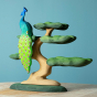 Bumbu plastic-free wooden Peacock toy figure balanced on top of a Bumbu wooden Bonsai tree in front of a blue background
