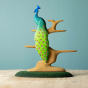 Close up of a Bumbu children's wooden Peacock toy balanced on the Bumbu wooden bird tree toy