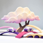 Close up of some Bumbu wooden car toys on arches in front of the purple Japanese winter maple tree toy