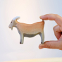 Hand holding the Bumbu eco-friendly plastic free childrens billy goat animal figure in front of a white background