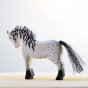 Bumbu eco-friendly wooden white horse toy figure on a wooden worktop in front of a white background