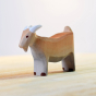 Close up of the Bumbu eco-friendly wooden billy goat animal figure stood on a light wooden work top in front of a white background