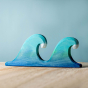Bumbu Wooden Waves. The toy sits on a wooden surface against a blue background. The two wave piece is shown.