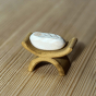 Bumbu Handmade Wooden baby Jesus in a white painted blanket and crib figure on a wooden table.