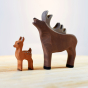 Bumbu plastic free childrens brown fawn figure stood next to a large wooden moose toy on a wooden background