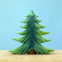 Bumbu Large Wooden Handmade Fir Tree in various shades of green, and a brown tree trunk displayed on a wooden table with a blue background